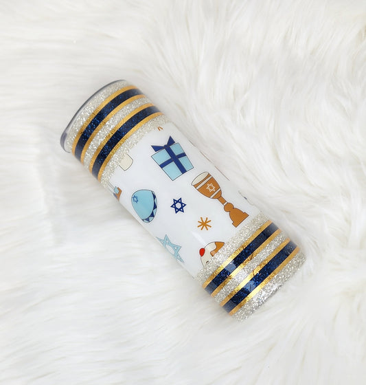 Chanukah themed tumbler made with silver and blue glitter, finished with gold striping.