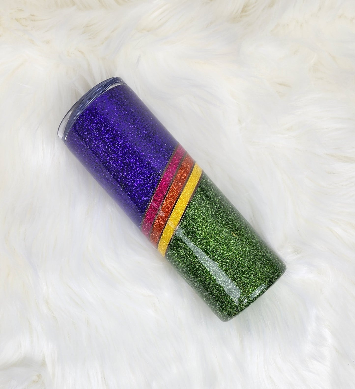 Rainbow glitter split wave tumbler. Purple and green dominant, pink, orange and yellow stripes with textured bron metallic pinstriping to separate the colours.